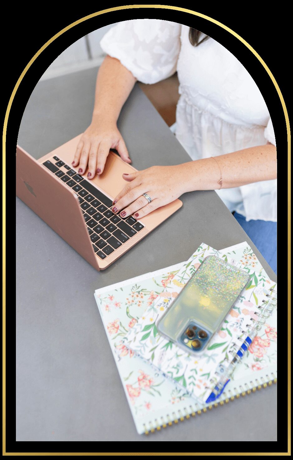Laptop and journal on Katelin's desk — the telehealth setup.